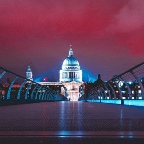 Millennium Bridge At Night With St Pauls At The End With Colorful Red Night Sky